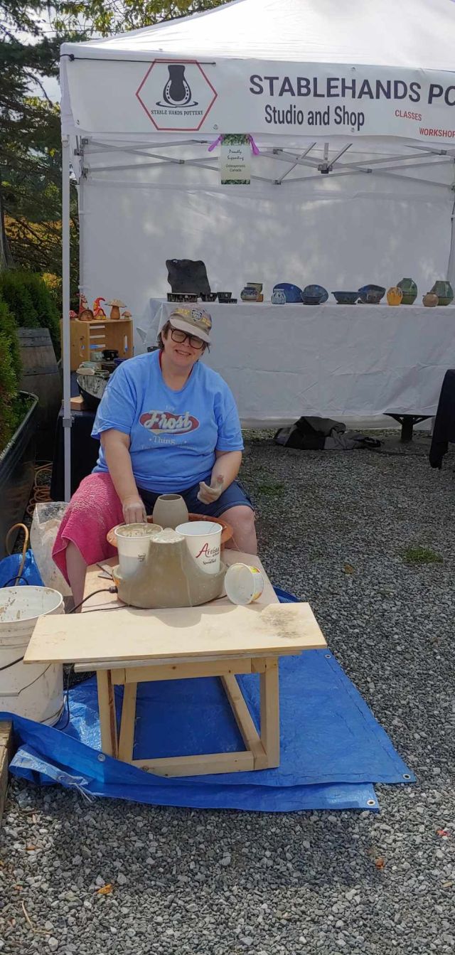 Emma at the wheel at a market in 2024.