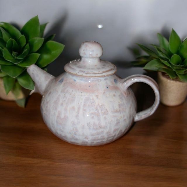 Small teapots after being put together, waiting to be bisque fired.